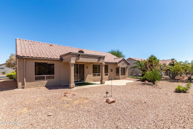 15874 W Wildflower Dr, Surprise, AZ 85374 - back of property featuring a tiled roof, stucco siding, and a patio