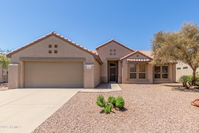 15874 W Wildflower Dr, Surprise, AZ 85374 - mediterranean / spanish-style home featuring stucco siding, driveway, an attached garage, and a tile roof