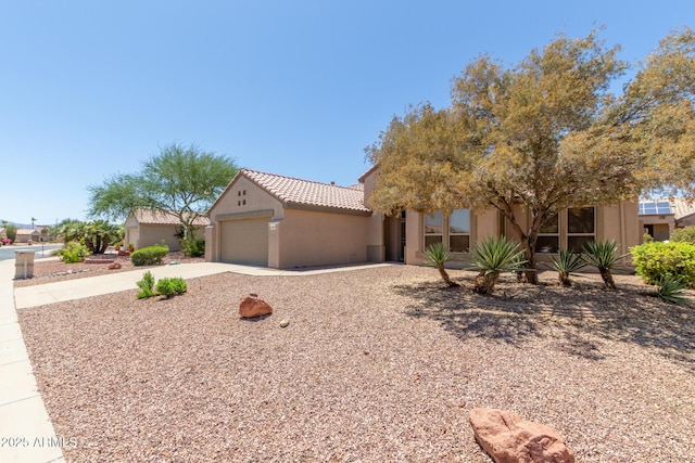 15874 W Wildflower Dr, Surprise, AZ 85374 - view of front of property featuring driveway, stucco siding, a garage, and a tiled roof