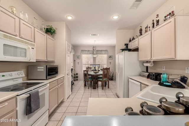 15874 W Wildflower Dr, Surprise, AZ 85374 - kitchen featuring white appliances, light tile patterned floors, light countertops, and recessed lighting