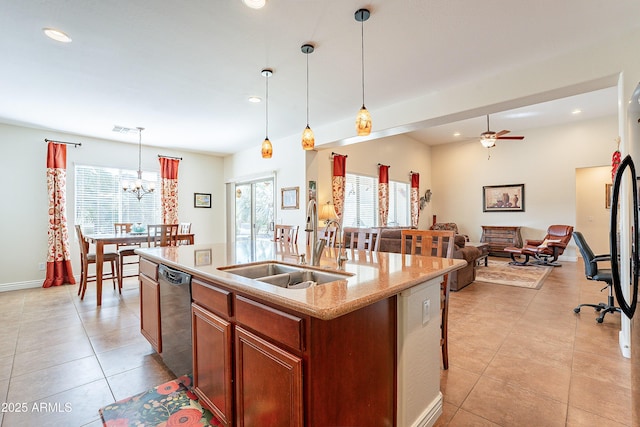 kitchen featuring light tile patterned flooring, decorative light fixtures, dishwasher, sink, and a kitchen island with sink