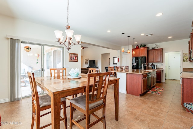 dining area with sink and an inviting chandelier