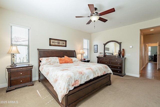 bedroom with light colored carpet and ceiling fan