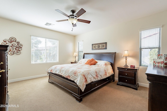 bedroom with light colored carpet and ceiling fan