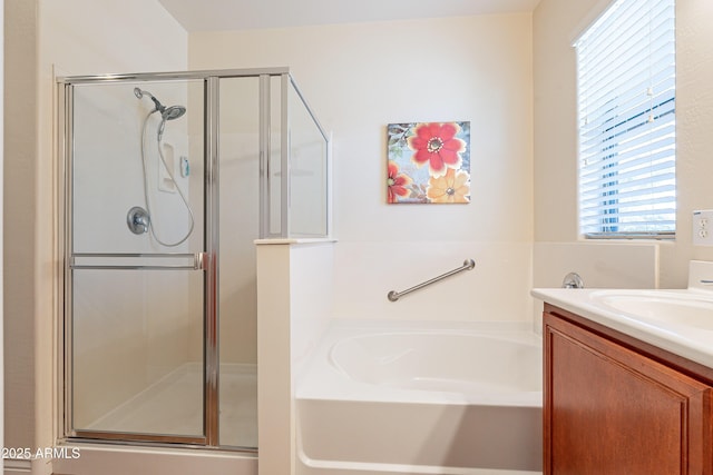 bathroom with vanity and separate shower and tub