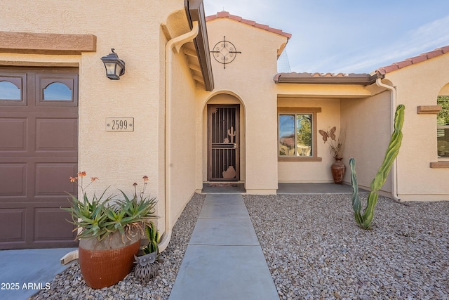 doorway to property with a garage