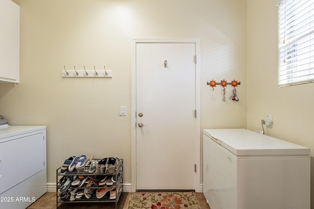 washroom featuring independent washer and dryer and cabinets