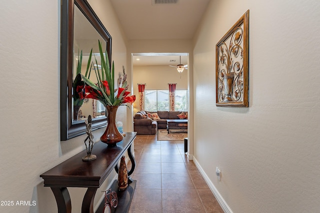 hallway featuring dark tile patterned flooring