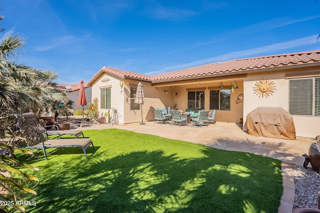 back of house featuring a yard and a patio area