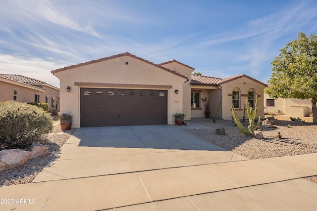 mediterranean / spanish-style home with a garage