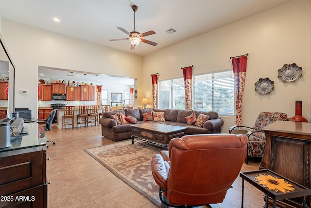 living room with light tile patterned floors and ceiling fan