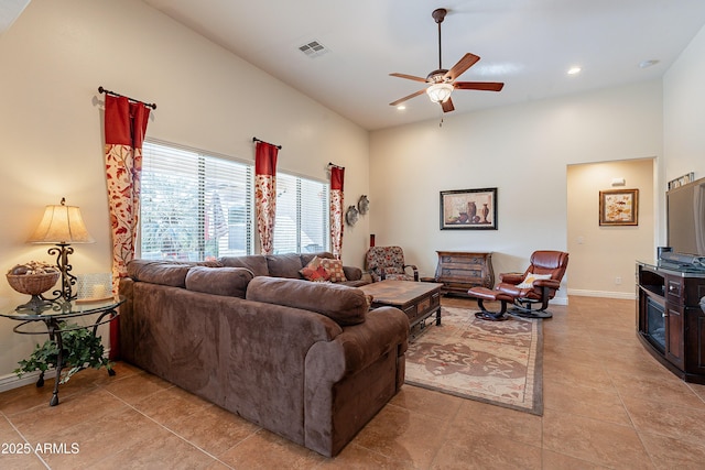 living room with ceiling fan and light tile patterned floors