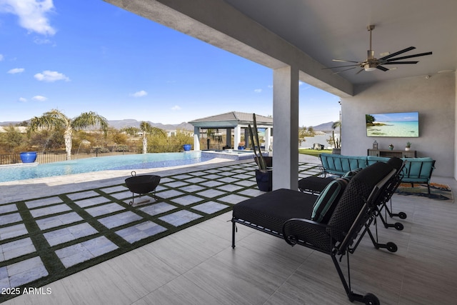 view of patio / terrace featuring an outdoor structure, pool water feature, and ceiling fan