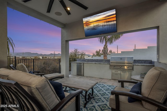 view of patio / terrace featuring exterior kitchen, area for grilling, and ceiling fan