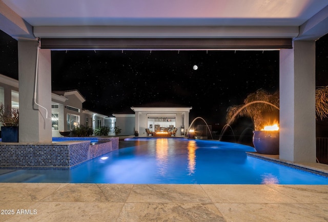 view of swimming pool with pool water feature, a hot tub, and a patio area