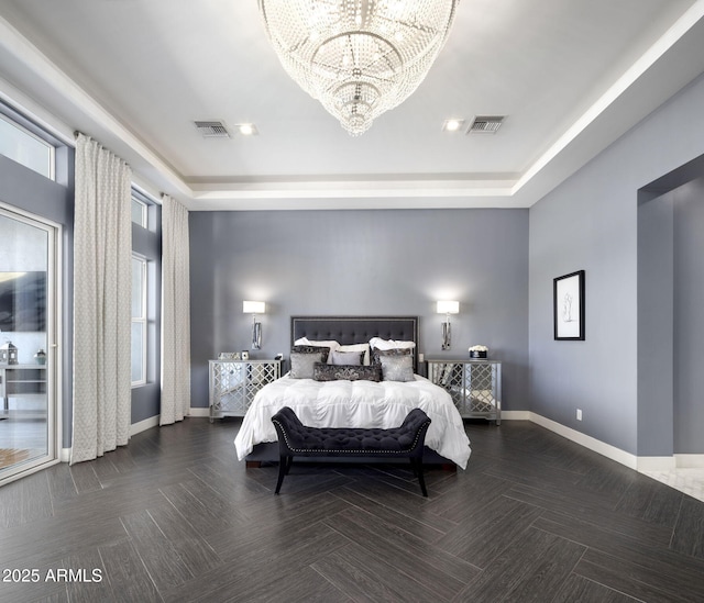 bedroom with a chandelier and a tray ceiling