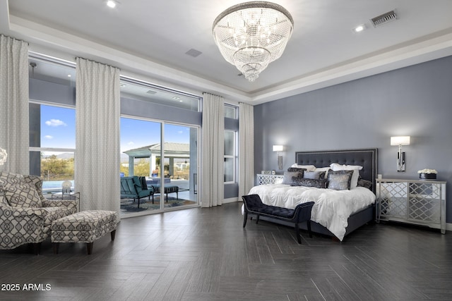 bedroom featuring a tray ceiling, access to outside, dark parquet floors, and a chandelier