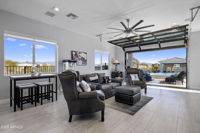 living room featuring ceiling fan and plenty of natural light