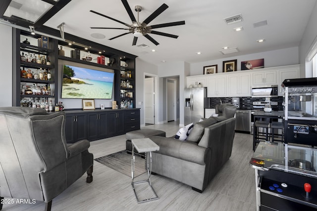 living room with indoor bar and ceiling fan