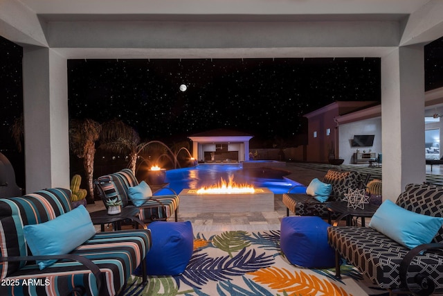 view of pool with a fire pit and a patio