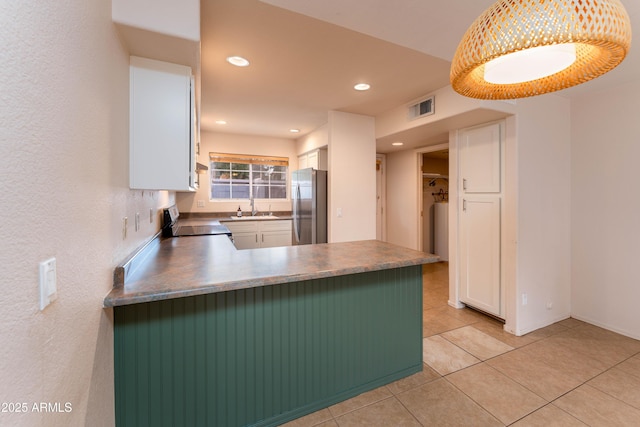 860 N Mcqueen Rd Unit 1151, Chandler, AZ 85225 - kitchen with freestanding refrigerator, range, white cabinets, light tile patterned floors, and a peninsula