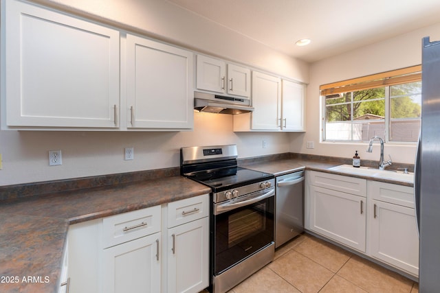 860 N Mcqueen Rd Unit 1151, Chandler, AZ 85225 - kitchen with stainless steel appliances, under cabinet range hood, dark countertops, white cabinets, and recessed lighting