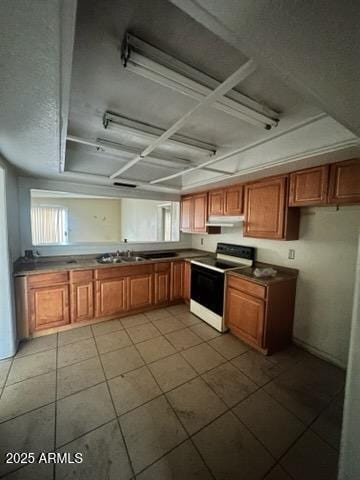 kitchen featuring tile patterned flooring, white electric range, and sink