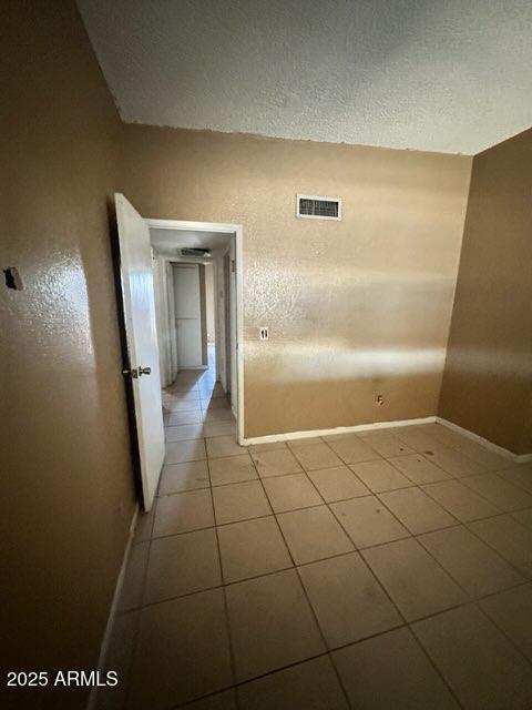 corridor featuring light tile patterned floors