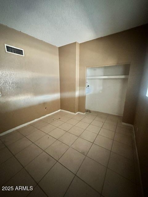 empty room with tile patterned floors