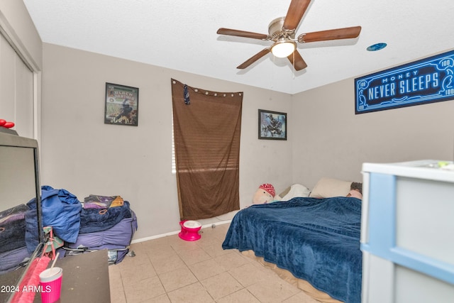 tiled bedroom with ceiling fan