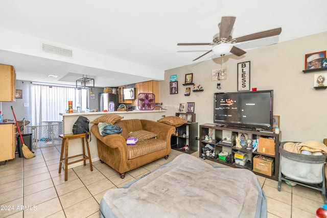 living room featuring light tile patterned floors and ceiling fan