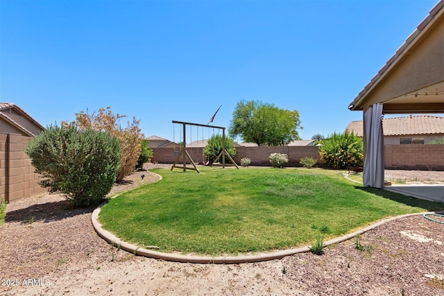 view of yard featuring a playground and a fenced backyard