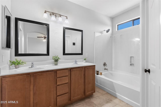 full bath featuring a sink, double vanity,  shower combination, and tile patterned flooring