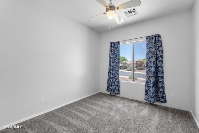 unfurnished room with carpet flooring, a ceiling fan, and visible vents