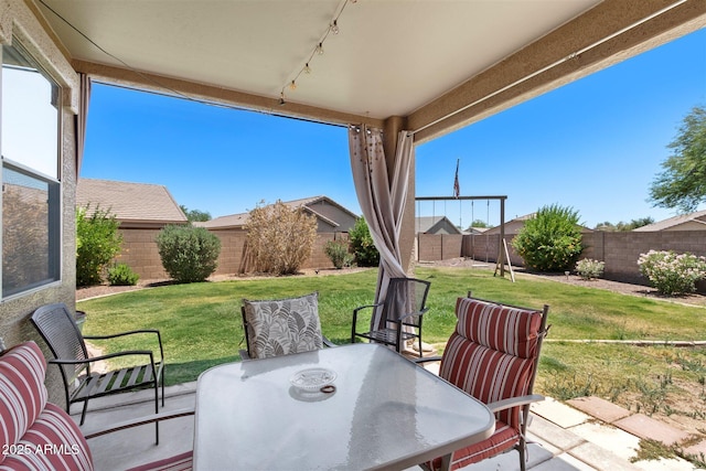 view of patio with outdoor dining area and a fenced backyard