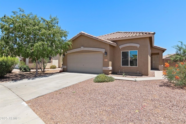 mediterranean / spanish-style home featuring stucco siding, a garage, concrete driveway, and a tile roof