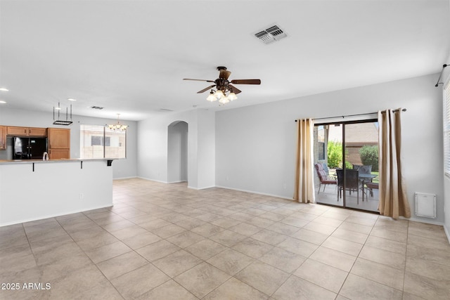 unfurnished living room featuring visible vents, baseboards, ceiling fan with notable chandelier, recessed lighting, and arched walkways