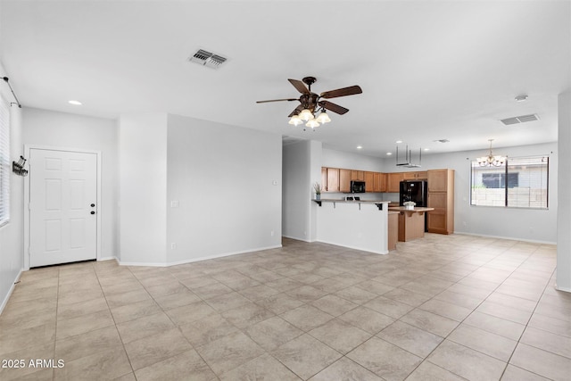 unfurnished living room with recessed lighting, ceiling fan with notable chandelier, visible vents, and baseboards