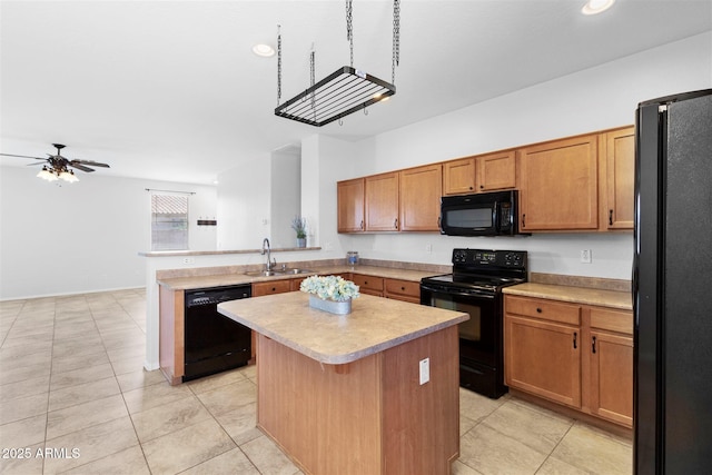 kitchen with a kitchen island, ceiling fan, light countertops, black appliances, and a sink