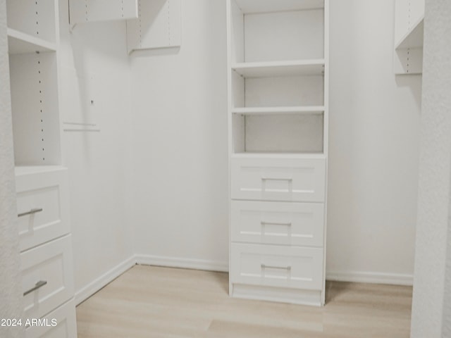 walk in closet featuring light hardwood / wood-style floors