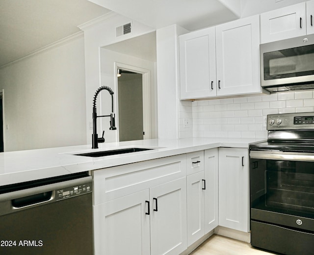 kitchen featuring sink, white cabinets, and stainless steel appliances