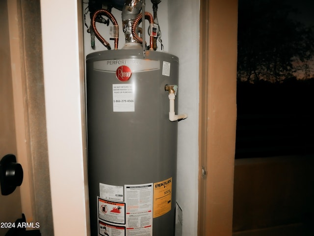 utility room featuring water heater