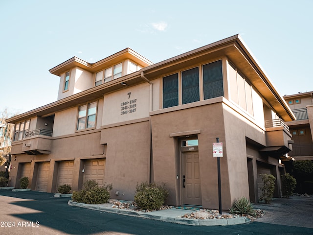 multi unit property with a balcony and a garage