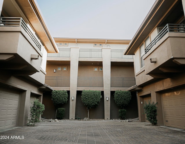 exterior space with a balcony and a garage