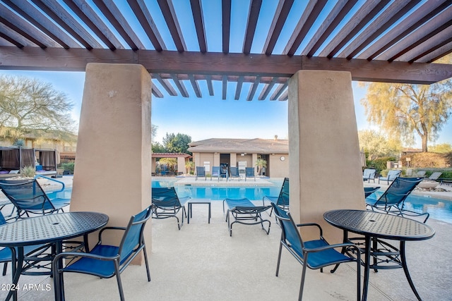 view of patio / terrace with a community pool and a pergola