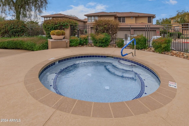 view of swimming pool featuring a community hot tub