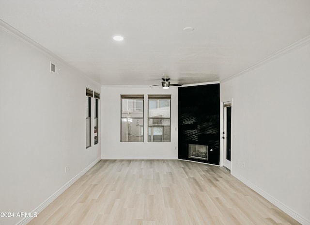 unfurnished room featuring light hardwood / wood-style floors, ornamental molding, and ceiling fan