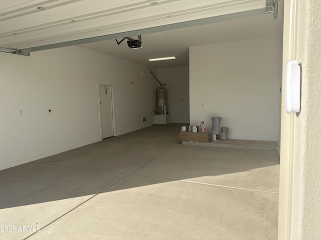 garage with gas water heater, a garage door opener, and baseboards