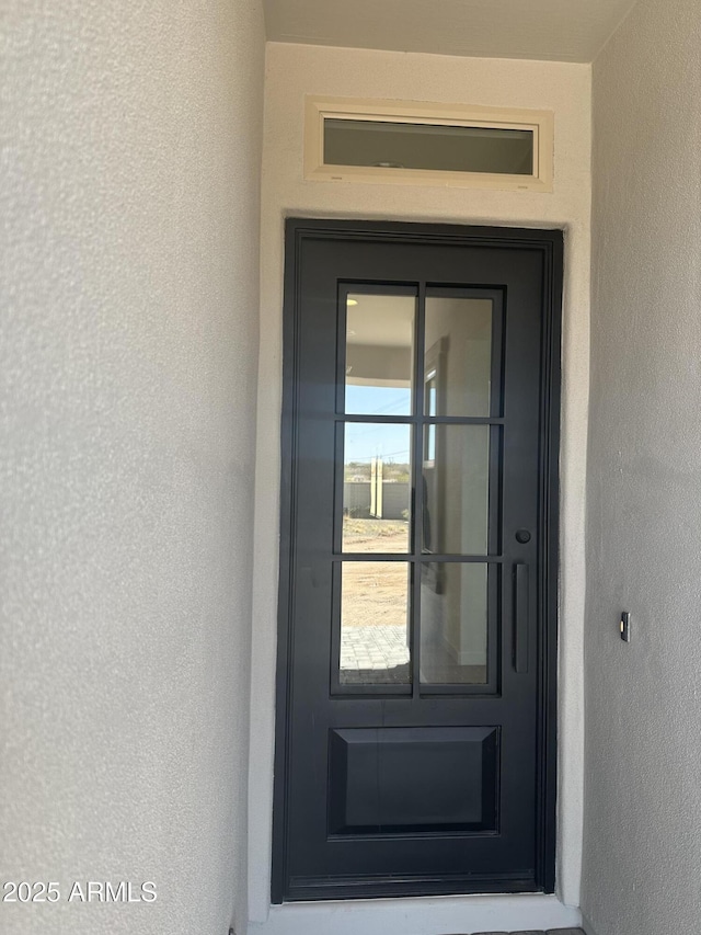 property entrance featuring stucco siding