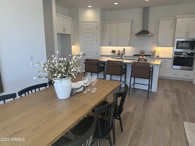 dining room featuring recessed lighting and wood finished floors